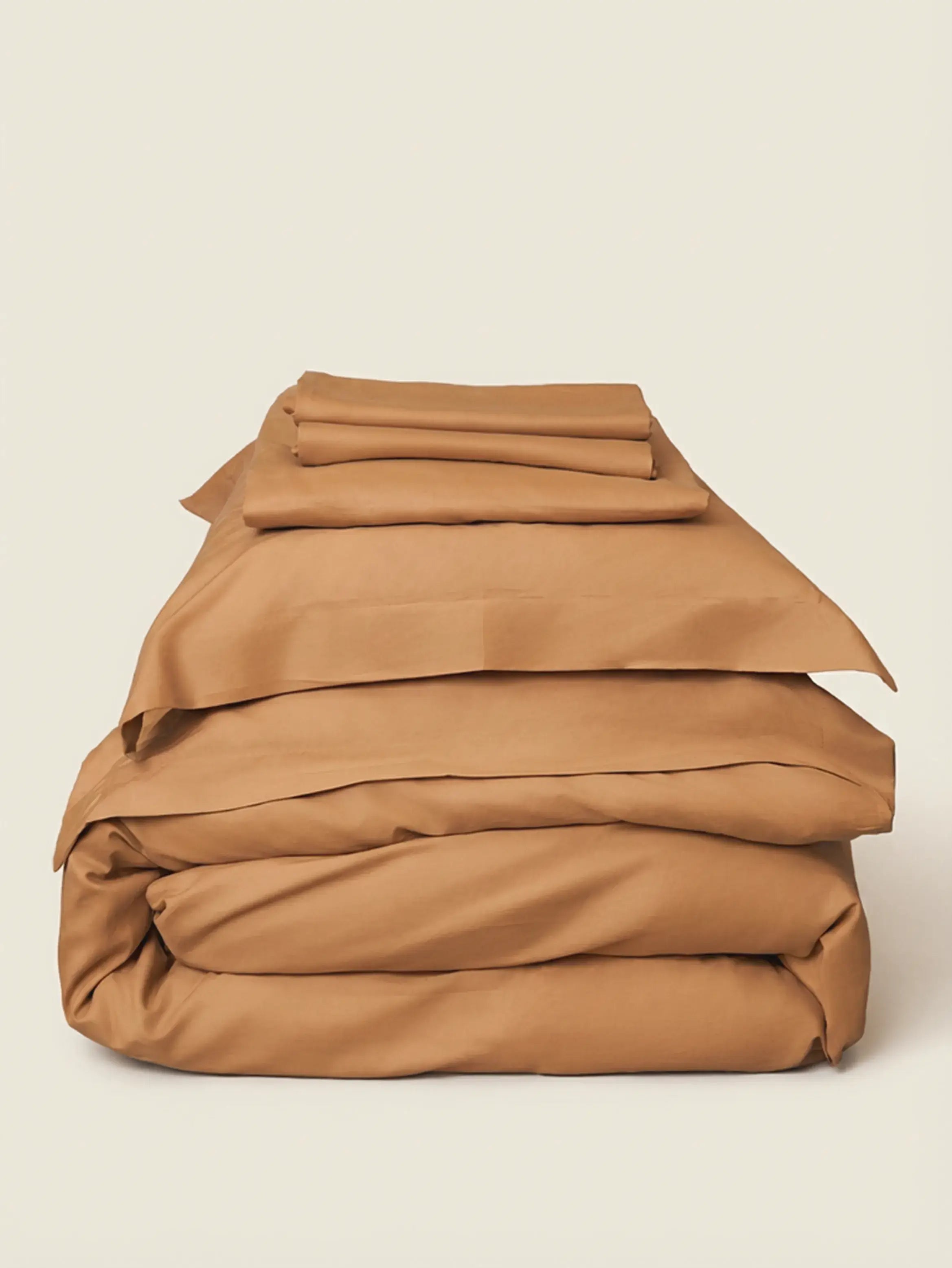 Sateen Bedding Set - Desert Sand stacked neatly, showcasing modern beige fabric perfect for effortless layering.
